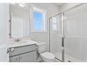 Clean bathroom featuring a glass shower, vanity, and a large window at 2042 Fishamble St, Fuquay Varina, NC 27526