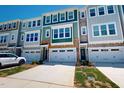 Townhome exterior featuring modern architecture, neutral colors, and attached garages at 2337 Bay Minette Sta # 553, Apex, NC 27502