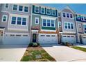 View of townhome exteriors featuring contemporary design and attached garages at 2337 Bay Minette Sta # 553, Apex, NC 27502