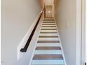 Interior shot of stairs showcasing wood railing, white risers and light gray steps at 2337 Bay Minette Sta # 553, Apex, NC 27502