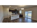 Open concept kitchen featuring a center island, stainless steel appliances, and sliding glass doors at 566 John Stark Dr, Fuquay Varina, NC 27526