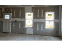 Spacious living room with large windows and a fireplace at 448 Little River Dr, Zebulon, NC 27597