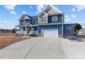Inviting home boasts a large driveway and garage, offering plenty of space for vehicles at 5554 Lake Vista Ct, Rocky Mount, NC 27803