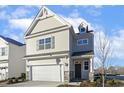 Two-story house with beige siding, stone accents, and a two-car garage at 182 Ford Meadows Dr, Garner, NC 27529