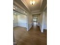 Bright hallway with wood-look floors and detailed trim, seamlessly connecting living spaces at 23 Quail Pt Cir, Clayton, NC 27520