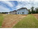 View of the back of the home highlighting the spacious backyard and privacy at 328 Bishop Lane, Sanford, NC 27330