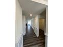 Inviting hallway with beautiful hardwood floors, elegant trim, and convenient access to various rooms in the home at 52 Quail Point Cir, Clayton, NC 27520