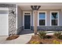 Inviting front entrance with a dark-colored door and stone accents at 1078 Gibson House Dr, Burlington, NC 27215