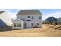 Rear view of the house showcasing a sunroom and a large backyard at 1078 Gibson House Dr, Burlington, NC 27215
