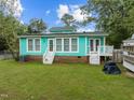 Spacious backyard with lush green grass, two patio decks and ample room for outdoor activities and relaxation at 802 N Franklin St, Wake Forest, NC 27587