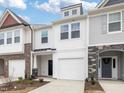 Charming townhome showcasing a light and airy exterior with a one-car garage and manicured front yard at 18 Clementine Street St # 207, Angier, NC 27501