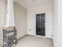 Inviting front porch featuring stone accents, a stylish front door, and a cozy entryway to the home at 18 Clementine Street St # 207, Angier, NC 27501
