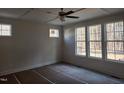 Bright primary bedroom featuring large windows, a ceiling fan, and ample natural light at 846 Cabin Creek Crk, Pittsboro, NC 27312