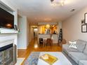 Inviting living room featuring hardwood floors, a decorative fireplace, and an open layout at 1001 Hillsborough St # 304, Raleigh, NC 27603