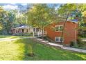 Brick home featuring beautiful landscaping and a charming walkway at 3615 Octavia St, Raleigh, NC 27606