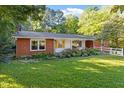 Cozy red brick home with a manicured lawn and beautiful landscaping at 3615 Octavia St, Raleigh, NC 27606