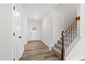 Bright foyer with stairs and wood-look flooring at 420 Oak Park Blvd, Youngsville, NC 27596