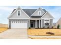 Gray two-story house with white garage door and landscaping at 420 Oak Park Blvd, Youngsville, NC 27596