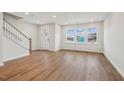 Bright living area with hardwood floors and large windows overlooking a park at 607 Hillfarm Dr, Wake Forest, NC 27587