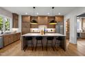 Modern kitchen with large island, hardwood floors, and stainless steel appliances at 3723 Bellevue Rd, Raleigh, NC 27609