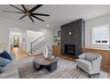 Bright living room with a fireplace, hardwood floors, and stylish ceiling fan at 3723 Bellevue Rd, Raleigh, NC 27609