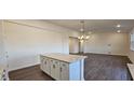 Open concept kitchen with an island and granite countertops that flows into the dining room at 141 Robert Howe Dr, Fuquay Varina, NC 27526
