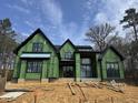 New construction home showcases its exterior framing and window installation, revealing its modern architectural design at 504 Colvard Woods Way Way, Durham, NC 27713
