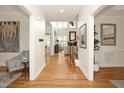 Bright foyer with hardwood floors, staircase, and views into the living spaces at 3009 Gentle Breezes Ln, Raleigh, NC 27614