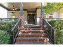 Inviting front porch with brick steps, decorative pillars, and a classic dark wood door at 3009 Gentle Breezes Ln, Raleigh, NC 27614