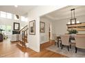 Open-concept living and dining area with hardwood floors and natural light at 3009 Gentle Breezes Ln, Raleigh, NC 27614
