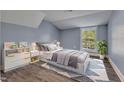 Cozy bedroom with a large window, stylish decor, and a comfortable bed on top of an accent rug at 505 S Magnolia Ave, Dunn, NC 28334