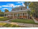 Charming home with a metal roof, brick accents, and an inviting front porch on a tree-lined street at 505 S Magnolia Ave, Dunn, NC 28334
