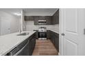 Modern kitchen featuring dark cabinetry, stainless steel appliances, and granite countertops at 804 Pryor St # 49, Mebane, NC 27302