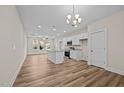 Modern kitchen with white cabinets, granite countertops, and an island at 806 Pryor St # 50, Mebane, NC 27302