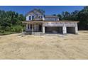 New construction featuring a two-story home with an attached three-car garage, showcasing modern design elements and future curb appeal at 236 Alden Way, Angier, NC 27501