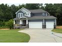 Charming two-story home with a welcoming front porch, a two-car garage, and beautiful landscaping at 236 Alden Way, Angier, NC 27501