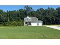 Charming home with attached two-car garage, welcoming front lawn, and mature trees providing privacy at 236 Alden Way, Angier, NC 27501