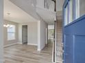 Bright foyer with hardwood floors, a staircase with a white banister, and views into adjacent living areas at 236 Alden Way, Angier, NC 27501