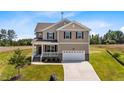 Charming two-story home with a front porch, attached garage, and well-maintained landscaping at 15 Diamond Creek Dr, Zebulon, NC 27597