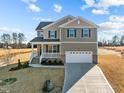 Two-story house with a neutral color scheme, a two-car garage, and a landscaped yard at 15 Diamond Creek Dr, Zebulon, NC 27597