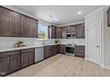 Modern kitchen featuring stainless steel appliances, dark wood cabinets, and white subway tile backsplash at 15 Diamond Creek Dr, Zebulon, NC 27597