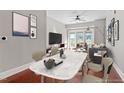 Bright living room with gray walls, dining area and balcony access at 222 Glenwood Ave # 508, Raleigh, NC 27603