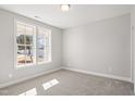 Neutral bedroom with carpet and double-hung window at 9148 Dupree Meadow Dr # 11, Angier, NC 27501
