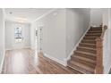 Welcoming entryway with hardwood floors, stairs, and white door at 9148 Dupree Meadow Dr # 11, Angier, NC 27501