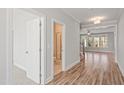 Hallway with wood floors leading to bathroom and living room at 9148 Dupree Meadow Dr # 11, Angier, NC 27501