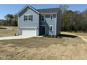 Charming two-story home with a garage and fresh sod in the front yard at 259 Johnson Ridge Way, Four Oaks, NC 27524