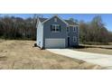 Charming two-story home with a garage and fresh sod in the front yard at 259 Johnson Ridge Way, Four Oaks, NC 27524