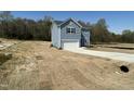 Two-story home featuring a garage and a freshly seeded lawn, offering a picturesque street view at 259 Johnson Ridge Way, Four Oaks, NC 27524