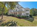 Traditional two-story home with charming front porch, beautiful landscaping, and a well-manicured lawn at 488 Colvard Farms Rd, Durham, NC 27713