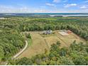 Stunning aerial view of estate featuring a large home, horse paddocks and a winding driveway at 548 Double N Rd, Pittsboro, NC 27312